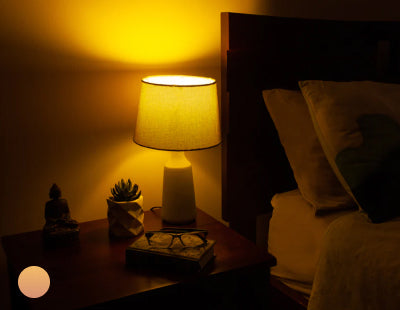 yellow glow from lamp on bedside table